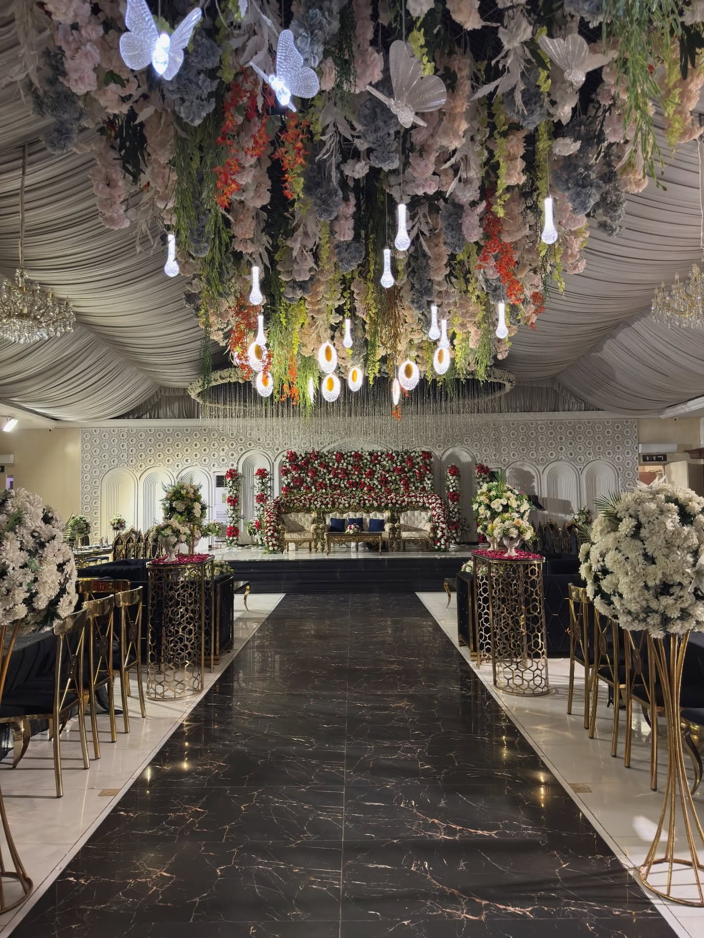 Hall aisle beneath a floral ceiling